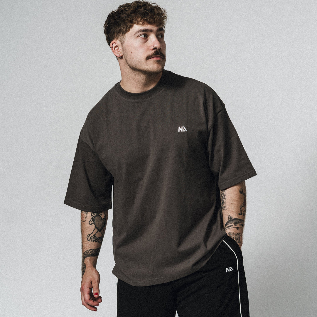NA's Oversized t-shirt er beskrevet som det perfekte pump cover, gennemført pasform og maksimal komfort. Det bløde og åndbare bomuld kombineret med det ikoniske oversized box fit - gør den ideel som både træningstrøje og casual hverdagslook. Med drop shoulders og et naturligt fald over brystet, der skaber en flatterende silhuet, går du aldrig galt i byen med den her t-shirt.